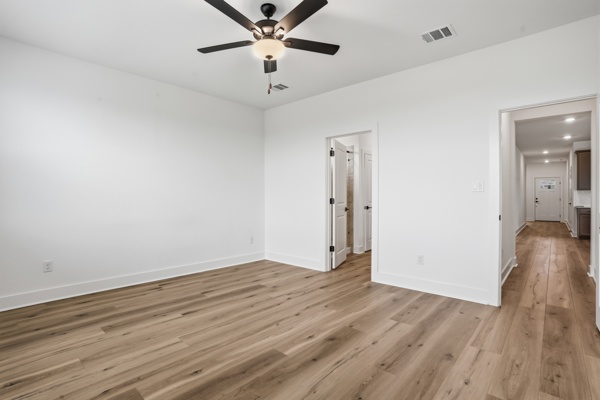 201 Prodigal Way Kyle, TX 78640 - Photo 15 of 22 Room featuring light-toned flooring, white walls, and a ceiling fan with integrated lighting