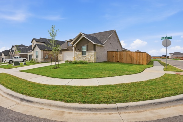 201 Prodigal Way Kyle, TX 78640 - Photo 2 of 22 The property features a well-maintained lawn and a private wooden fence