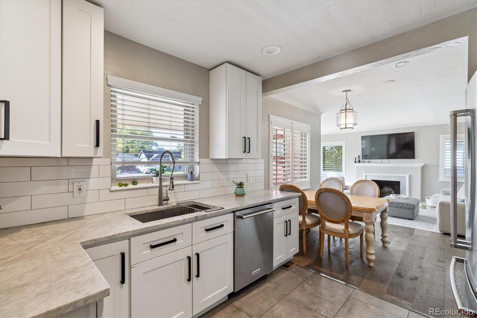 2660 Kearney Street Denver, CO 80207 - Photo 13 of 35 a kitchen with cabinets a sink and a stove top oven