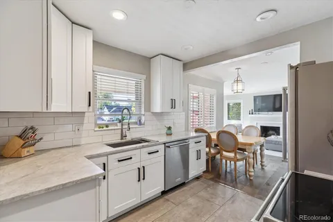 a kitchen with stainless steel appliances granite countertop a sink stove and cabinets
