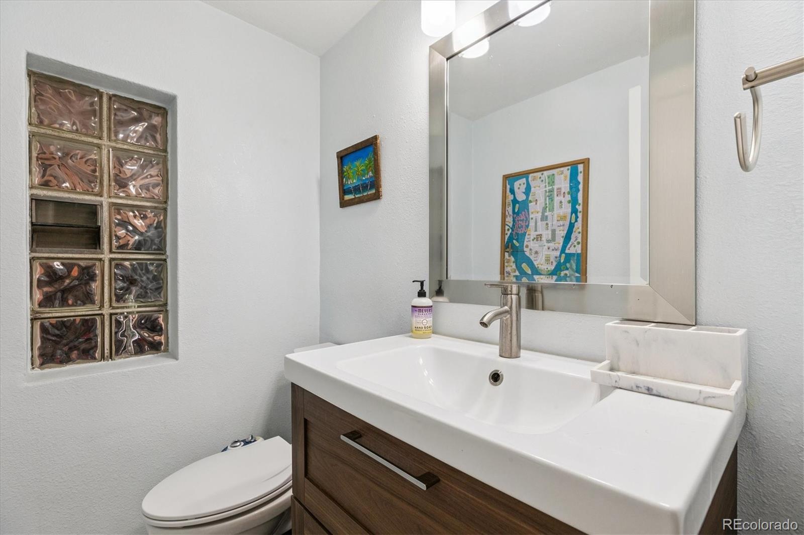 2660 Kearney Street Denver, CO 80207 - Photo 20 of 35 a bathroom with a sink a toilet and mirror