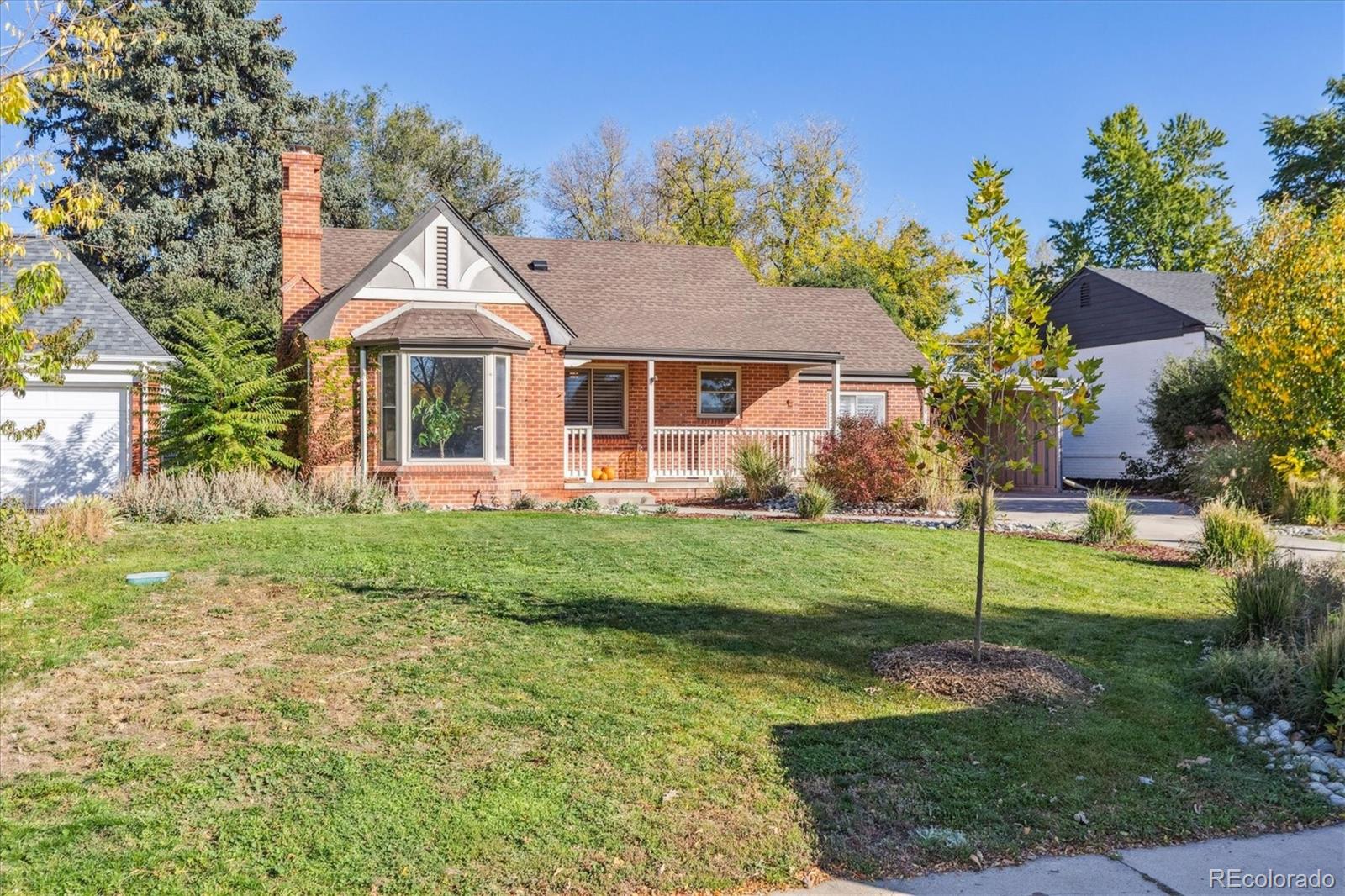 2660 Kearney Street Denver, CO 80207 - Photo 2 of 35 a front view of a house with a yard