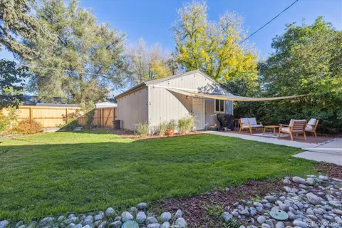 a backyard of a house with table and chairs