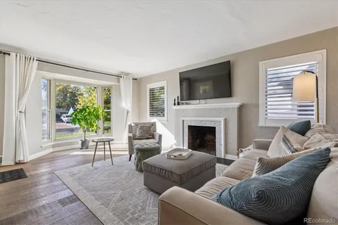 a living room with furniture fireplace and flat screen tv