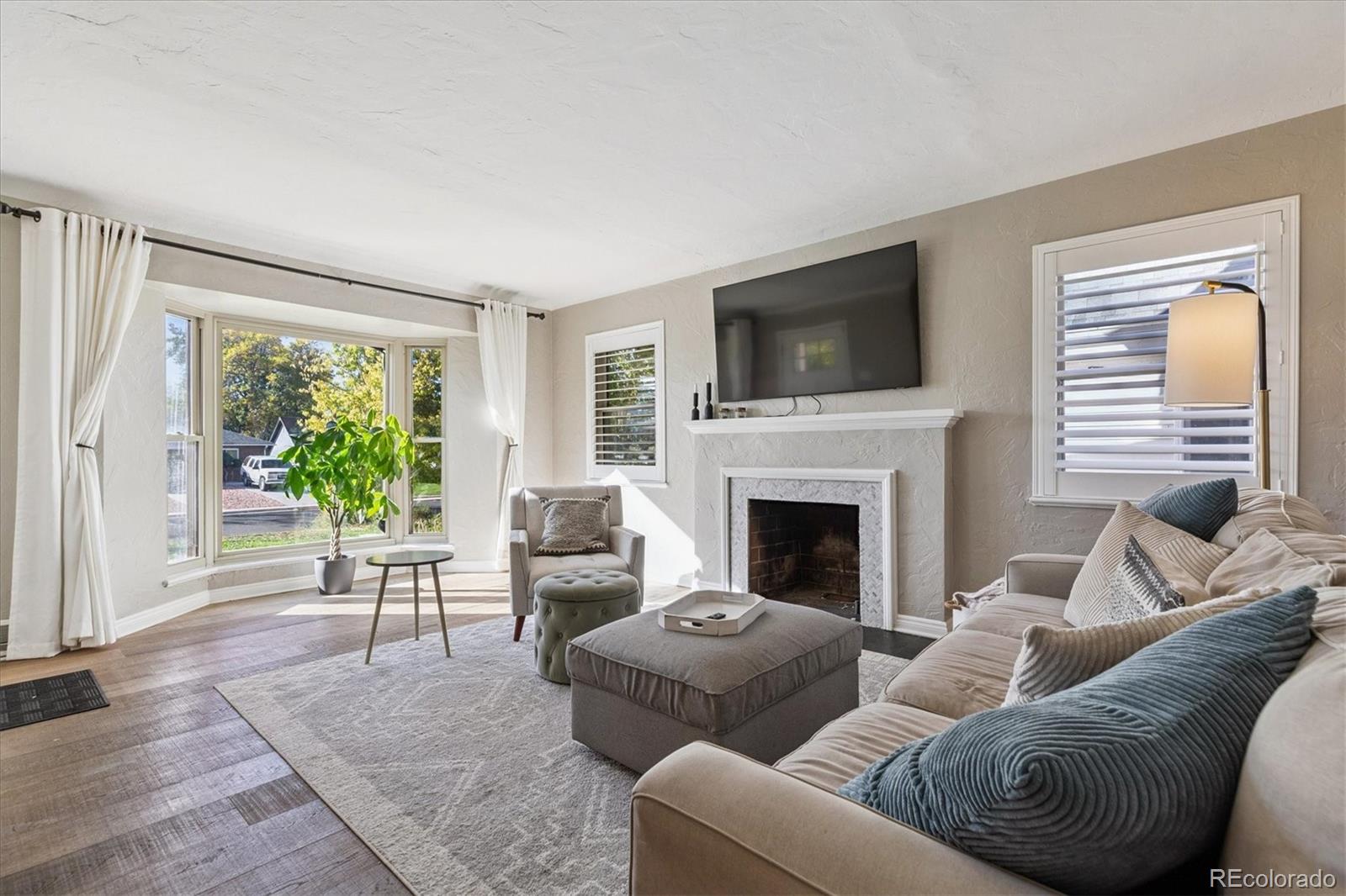 2660 Kearney Street Denver, CO 80207 - Photo 7 of 35 a living room with furniture fireplace and flat screen tv