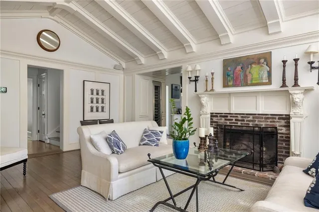 a bedroom with a bed a table and a flat screen tv