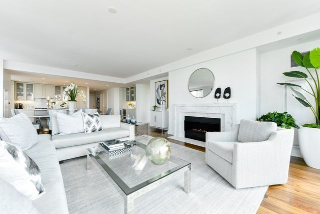a living room with furniture a fireplace and a potted plant