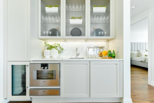 a view of white cabinets and wooden floor