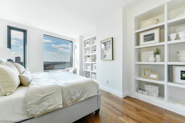 a bedroom with a large bed and a window