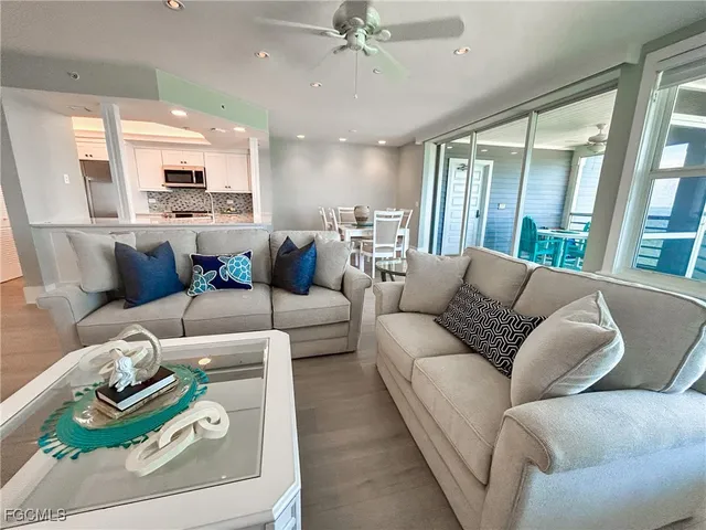 a living room with furniture a wooden floor and a rug