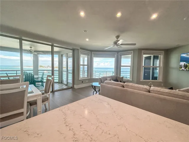 a large kitchen with stainless steel appliances kitchen island a large counter top and a wooden floors