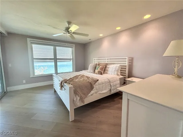 a bathroom with a granite countertop toilet a sink and a mirror