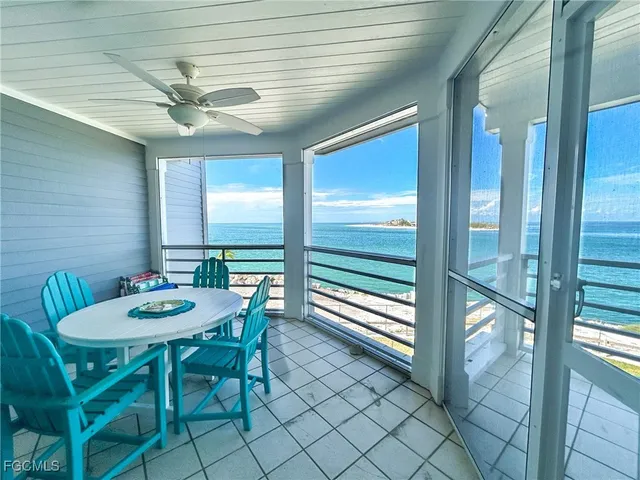 a view of a dining table and chairs in the balcony