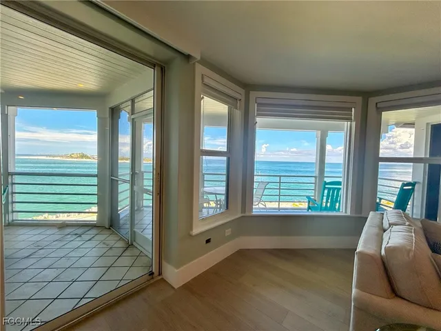 a living room with furniture and a floor to ceiling window