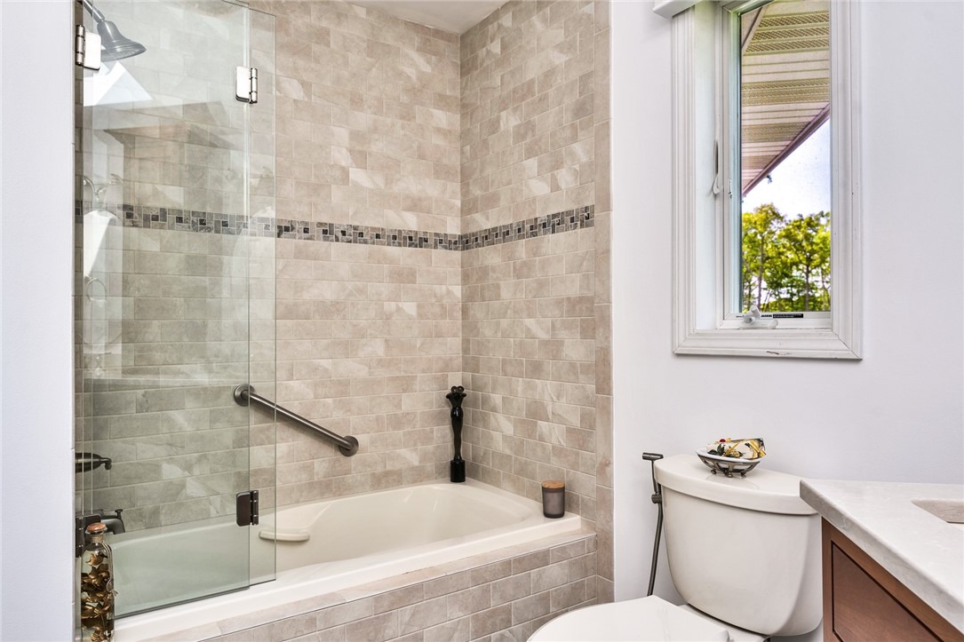 5 Wicklow Road Westerly, RI 02891 - Photo 20 of 37 The main bath features a tub/shower with a glass shower door.