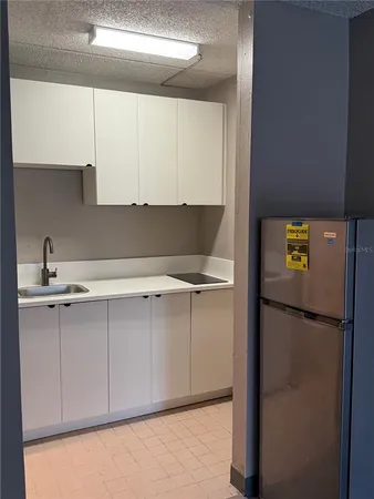a kitchen with a refrigerator and cabinets