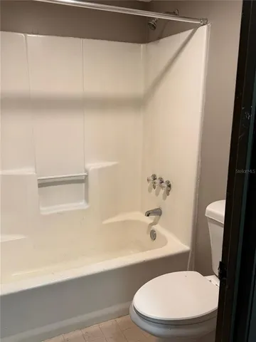 a bathroom with a toilet and a bathtub