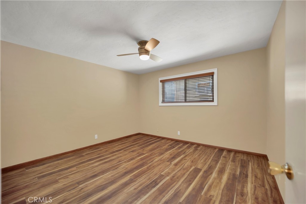 2214 2nd Street, Unit 6 Long Beach, CA 90803 - Photo 14 of 22 a view of a room with wooden floor and ceiling fan