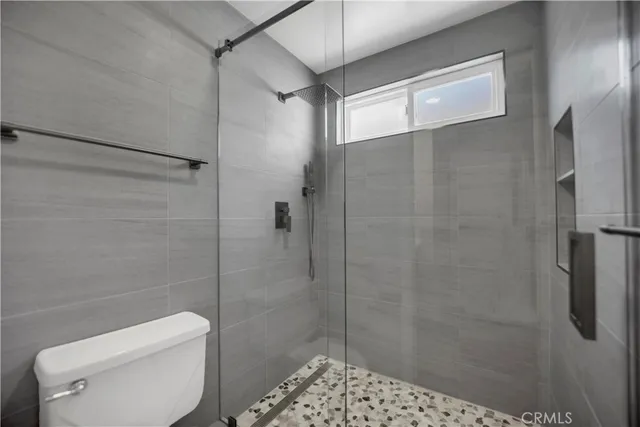 a bathroom with a shower and toilet