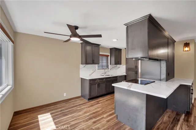 a kitchen with kitchen island sink and refrigerator