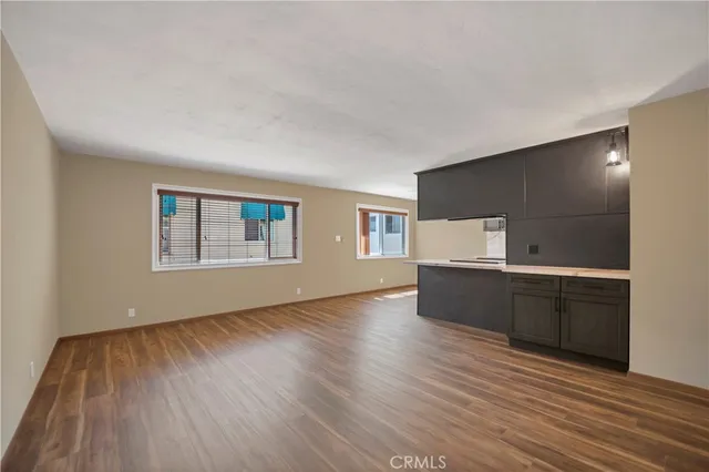 a living room with hard wood floors and a wooden floor