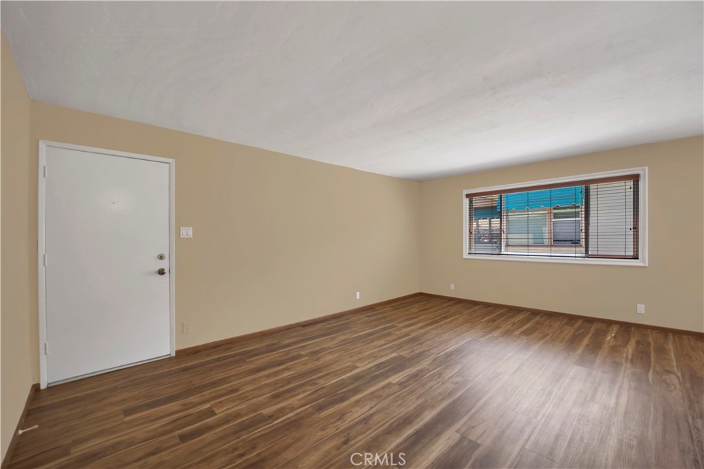 2214 2nd Street, Unit 6 Long Beach, CA 90803 - Photo 10 of 22 a view of an empty room with wooden floor and a window