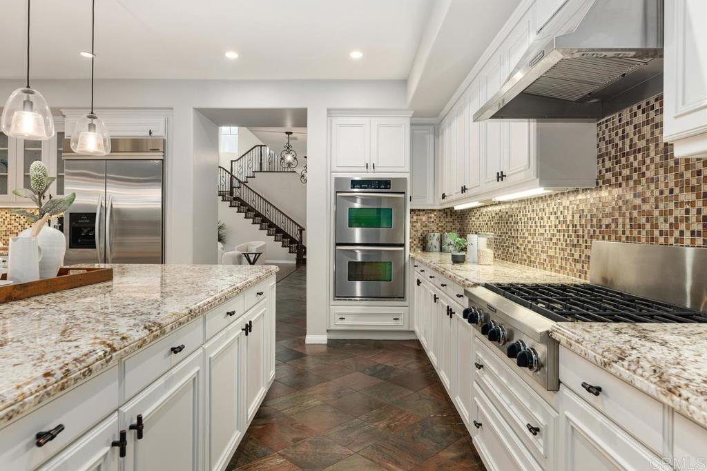 7627 Circulo Sequoia Carlsbad, CA 92009 - Photo 14 of 72 a kitchen with granite countertop a stove and cabinets