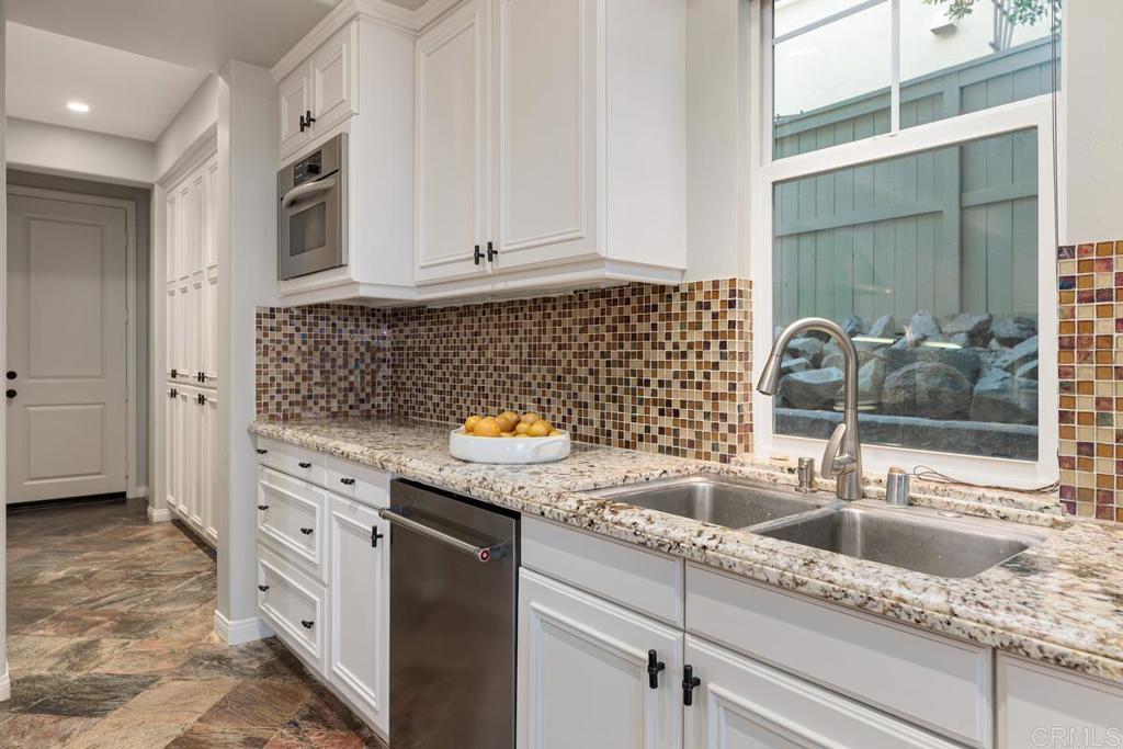 7627 Circulo Sequoia Carlsbad, CA 92009 - Photo 17 of 72 a kitchen with granite countertop a sink and a stove