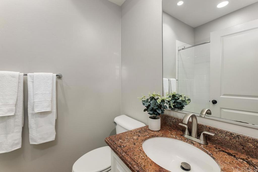 7627 Circulo Sequoia Carlsbad, CA 92009 - Photo 32 of 72 a bathroom with a granite countertop sink a toilet and a mirror