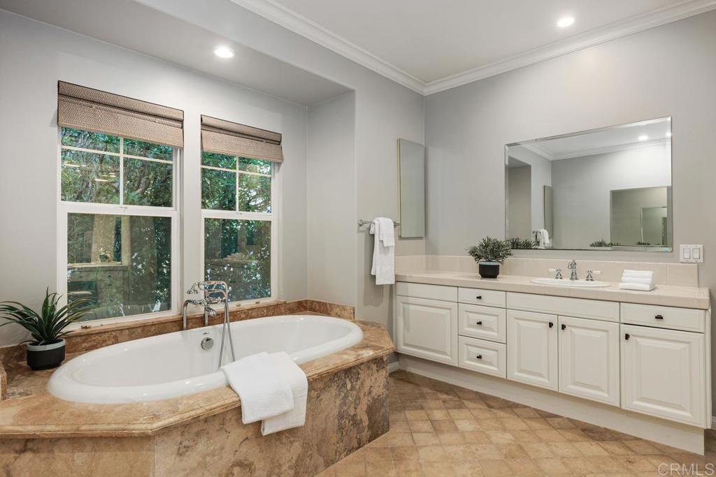 7627 Circulo Sequoia Carlsbad, CA 92009 - Photo 43 of 72 a spacious bathroom with a double vanity sink large mirror and a bathtub