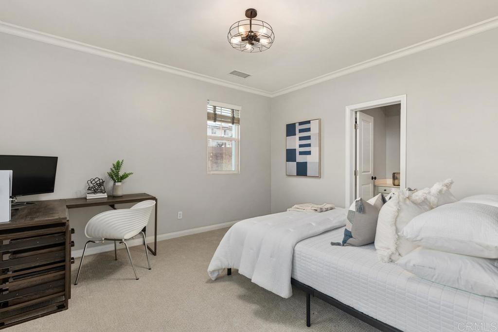 7627 Circulo Sequoia Carlsbad, CA 92009 - Photo 50 of 72 a bedroom with a bed and a chandelier