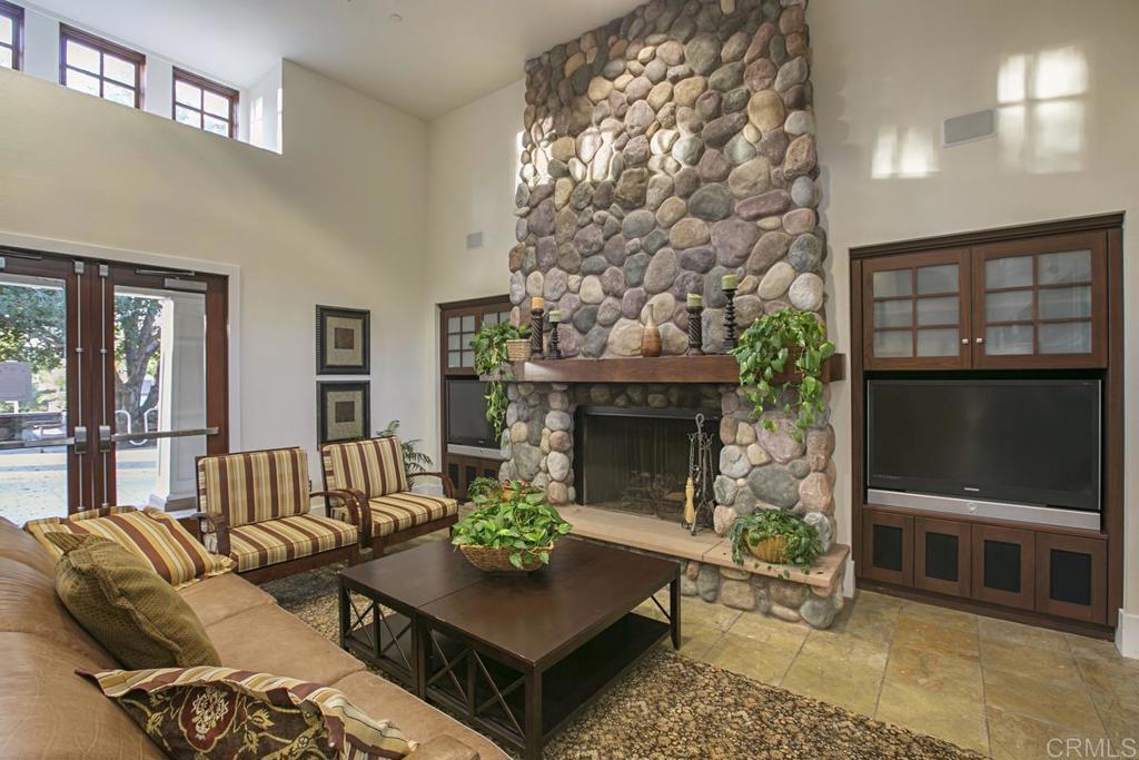 7627 Circulo Sequoia Carlsbad, CA 92009 - Photo 70 of 72 a living room with furniture a fireplace and a flat screen tv