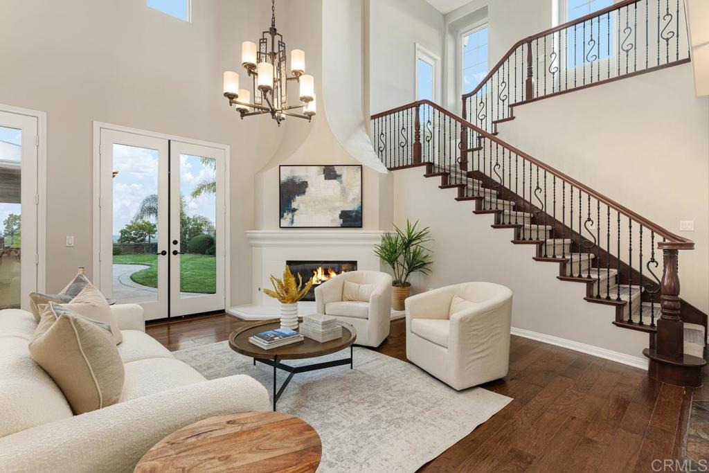 7627 Circulo Sequoia Carlsbad, CA 92009 - Photo 9 of 72 a living room with fireplace furniture and a chandelier