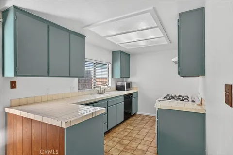 a kitchen with a sink cabinets and window