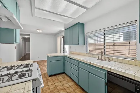 a kitchen with a sink stove and cabinets