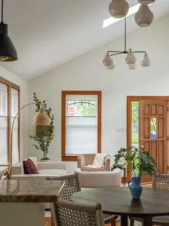 a dining room with furniture and window