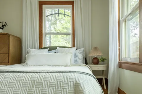 a bedroom with a bed and window