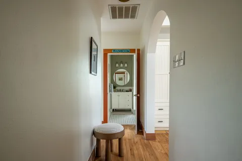 a view of a hallway with wooden door