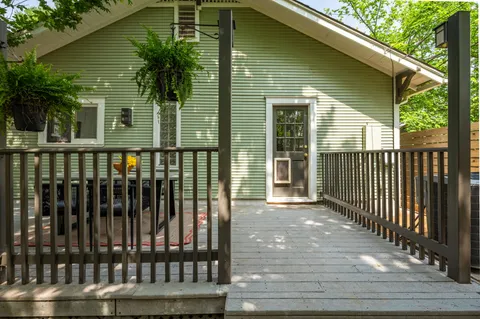 a view of a house with a wooden deck