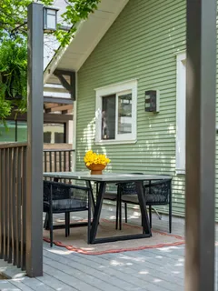 a view of a deck with table and chairs with wooden floor and fence
