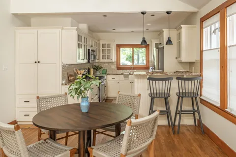 a view of a dining room with furniture and wooden floor