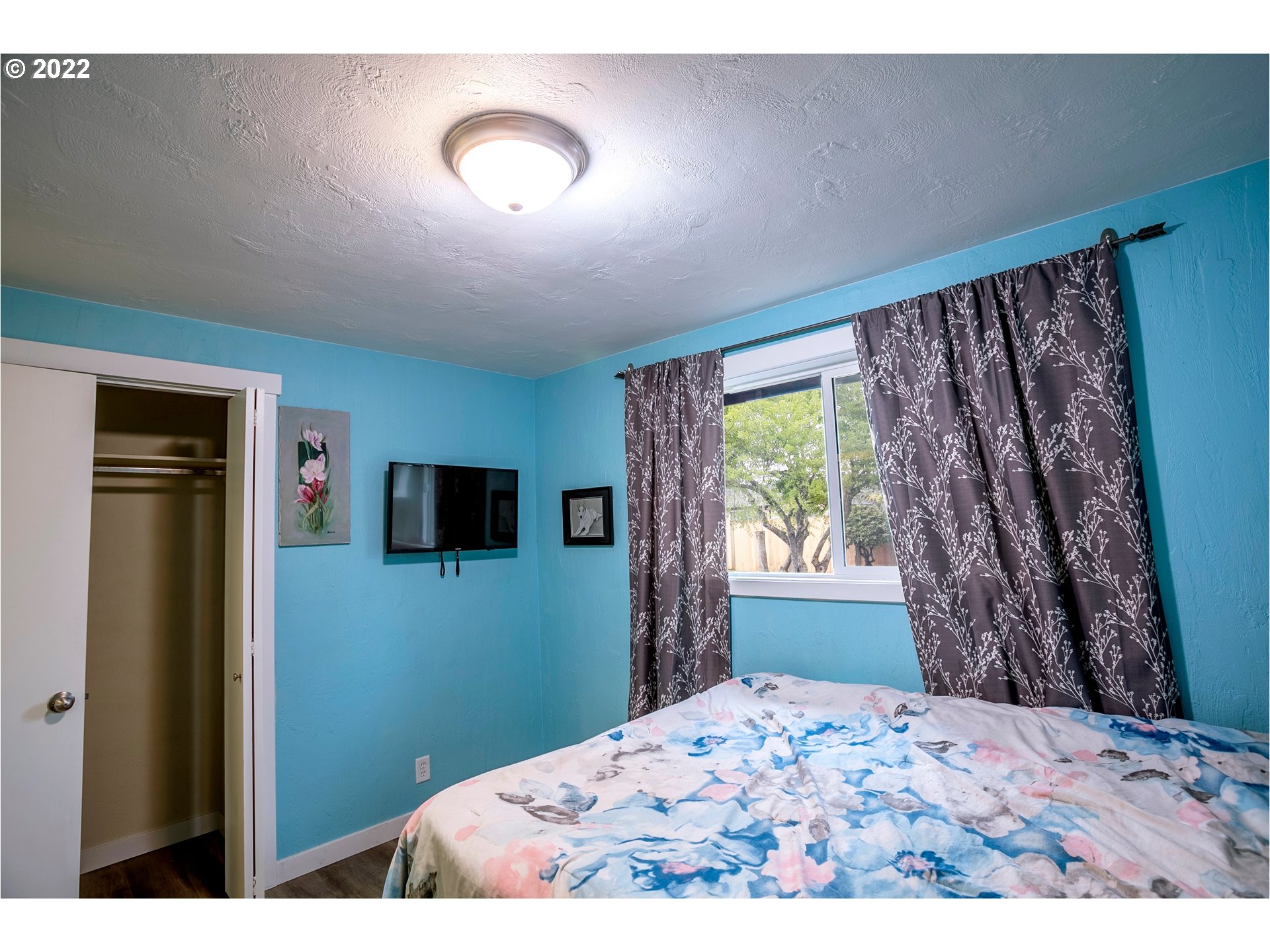450 South 39th Place Springfield, OR 97478 - Photo 20 of 28 a bedroom with a bed and a flat screen tv