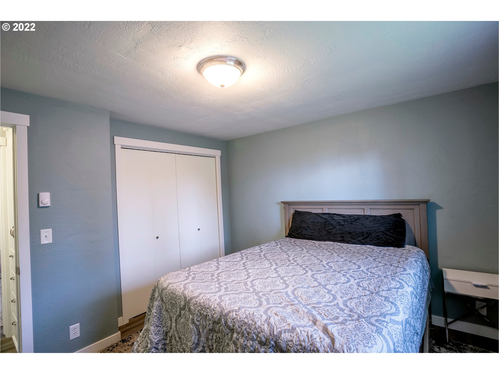 450 South 39th Place Springfield, OR 97478 - Photo 22 of 28 a bedroom with a bed and a night stand