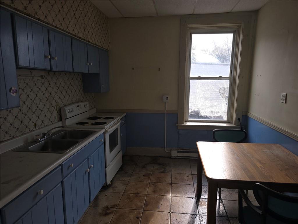 320 Main Street Fayette City, PA 15438 - Photo 22 of 28 a kitchen with a wooden cabinets and stove top oven
