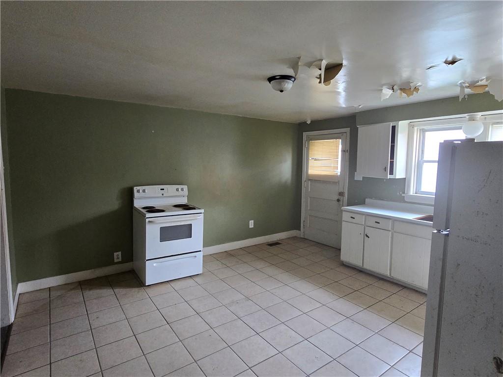 320 Main Street Fayette City, PA 15438 - Photo 6 of 28 a kitchen with granite countertop cabinets and white appliances