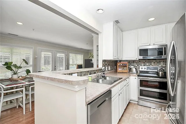 a kitchen with a sink stove and microwave