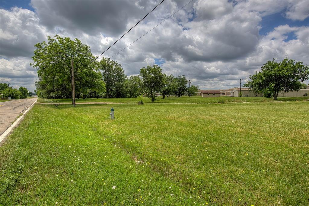 221 Maple Street Commerce, TX 75428 - Photo 15 of 19 a view of a big yard with a big yard and a fountain