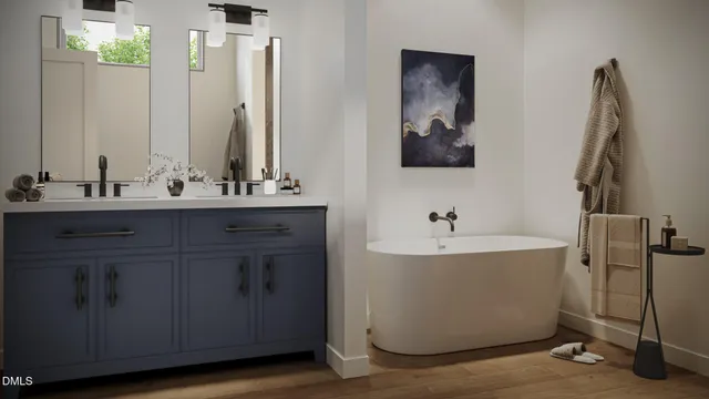 a bathroom with a double vanity sink a mirror and a bathtub