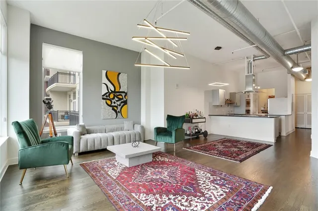 a living room with furniture rug and wooden floor