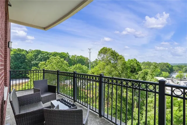 a balcony with wooden floor and outdoor space